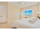 Light-filled main bedroom features ocean views, neutral paint, and tile flooring at 4427 S Atlantic Ave, Port Orange, FL 32127