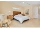Bright primary bedroom boasts nightstands, woven headboard, and light, neutral tones at 4427 S Atlantic Ave, Port Orange, FL 32127