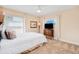 Cozy bedroom with neutral decor, complemented by a dresser and ambient lighting at 4427 S Atlantic Ave, Port Orange, FL 32127