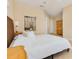 A brightly-lit bedroom with a comfortable bed and a decorative tapestry above it at 4427 S Atlantic Ave, Port Orange, FL 32127