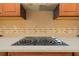 Close-up of a smooth cooktop with white knobs and decorative backsplash detail at 4427 S Atlantic Ave, Port Orange, FL 32127