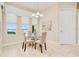 Light-filled dining area boasting ocean views and a modern glass table with seating for four at 4427 S Atlantic Ave, Port Orange, FL 32127