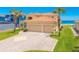 Lovely home near the beach, showcasing a terracotta roof, spacious driveway, and lush lawn at 4427 S Atlantic Ave, Port Orange, FL 32127