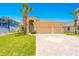 Stunning home featuring a terracotta roof, a paved driveway, and a lush green lawn at 4427 S Atlantic Ave, Port Orange, FL 32127