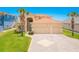 Charming home featuring a tile roof, palm trees, and a spacious three-car garage and brick paver driveway at 4427 S Atlantic Ave, Port Orange, FL 32127