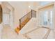 Inviting foyer with tiled floors, a staircase with iron railing, and decorative glass front door at 4427 S Atlantic Ave, Port Orange, FL 32127