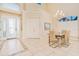 Elegant foyer with tiled floors, decorative glass front door, chandelier, and adjacent dining area at 4427 S Atlantic Ave, Port Orange, FL 32127