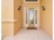 Elegant home entrance featuring decorative door and side lights, enhancing curb appeal at 4427 S Atlantic Ave, Port Orange, FL 32127