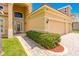 Inviting home exterior with decorative front door, two-car garage, and well-manicured landscaping at 4427 S Atlantic Ave, Port Orange, FL 32127