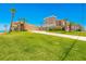 Inviting two-story beach house featuring a manicured lawn, long driveway, and attached two-car garage at 4427 S Atlantic Ave, Port Orange, FL 32127