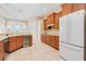Open kitchen showcasing wood cabinetry, tile floors, and an ocean view at 4427 S Atlantic Ave, Port Orange, FL 32127
