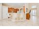 Spacious kitchen and entrance with tiled floors, white barstools, and dark wood cabinets at 4427 S Atlantic Ave, Port Orange, FL 32127