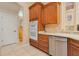 Kitchen with built-in oven, stainless steel dishwasher, and wooden cabinets at 4427 S Atlantic Ave, Port Orange, FL 32127