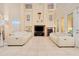 Bright, airy living room with high ceilings, fireplace, balcony view, and neutral decor at 4427 S Atlantic Ave, Port Orange, FL 32127