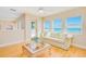 Bright living room featuring a sofa and large windows with ocean views at 4427 S Atlantic Ave, Port Orange, FL 32127