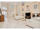 Bright, airy living room with high ceilings, fireplace, balcony view, and neutral decor at 4427 S Atlantic Ave, Port Orange, FL 32127