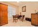 A quaint home office, decorated with a dark wooden desk, built-in shelving, and shuttered windows at 4427 S Atlantic Ave, Port Orange, FL 32127