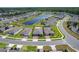 Beautiful aerial view of neighborhood featuring a scenic pond and well-maintained homes with lush landscaping at 460 Sarah Nicole Way, New Smyrna Beach, FL 32168