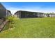 Large backyard with a screened-in lanai, offering plenty of space for outdoor activities at 460 Sarah Nicole Way, New Smyrna Beach, FL 32168