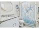 Charming bathroom featuring a vanity with granite countertops and nautical-themed decor at 460 Sarah Nicole Way, New Smyrna Beach, FL 32168