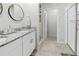 Beautiful bathroom featuring double vanity with granite countertop and walk-in shower with glass door at 460 Sarah Nicole Way, New Smyrna Beach, FL 32168