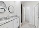 Bright bathroom featuring double vanity with granite countertop and walk-in shower with glass door at 460 Sarah Nicole Way, New Smyrna Beach, FL 32168