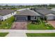 Charming single-story home with a well-manicured lawn, paver driveway, and inviting curb appeal at 460 Sarah Nicole Way, New Smyrna Beach, FL 32168