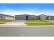 Charming single-story home with a brick driveway and well-maintained landscaping, enhancing curb appeal at 460 Sarah Nicole Way, New Smyrna Beach, FL 32168