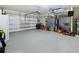 Spacious two-car garage with epoxy flooring and ample storage space, perfect for vehicles and tools at 460 Sarah Nicole Way, New Smyrna Beach, FL 32168