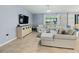 Comfortable living room with tile flooring, a large window, and stylish furnishings at 460 Sarah Nicole Way, New Smyrna Beach, FL 32168