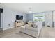 Comfortable living room with tile floors, lots of natural light, and stylish furnishings at 460 Sarah Nicole Way, New Smyrna Beach, FL 32168