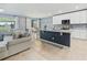 Open concept living area featuring a kitchen island, dining area and a comfortable living room at 460 Sarah Nicole Way, New Smyrna Beach, FL 32168
