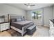 Relaxing main bedroom featuring a ceiling fan, comfortable bed, and scenic views from the window at 460 Sarah Nicole Way, New Smyrna Beach, FL 32168