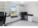 Bright office space with built-in shelves, storage, desk, and window view, ideal for productivity at 460 Sarah Nicole Way, New Smyrna Beach, FL 32168