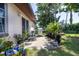 Backyard patio features a stainless steel grill and numerous potted plants, perfect for outdoor entertaining at 5 Greenfern Cir, Ormond Beach, FL 32174