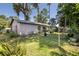 View of the backyard featuring lush landscaping and mature trees, offering shade and privacy at 5 Greenfern Cir, Ormond Beach, FL 32174
