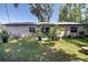 Expansive backyard featuring well-maintained lawn with mature trees and foliage and a patio at 5 Greenfern Cir, Ormond Beach, FL 32174