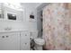 Bright bathroom featuring a white vanity, framed mirror, and shower with patterned curtain at 5 Greenfern Cir, Ormond Beach, FL 32174