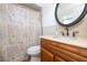 Bathroom featuring granite countertops, a vanity with wood cabinets and a decorative shower curtain at 5 Greenfern Cir, Ormond Beach, FL 32174