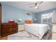 This bedroom is painted in a calming blue with a ceiling fan and a window to let in natural light at 5 Greenfern Cir, Ormond Beach, FL 32174