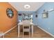 Dining room features stylish lighting, wood flooring, and colorful accent walls for a warm, inviting atmosphere at 5 Greenfern Cir, Ormond Beach, FL 32174