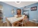 Charming dining room featuring blue walls, wood floors and a decorative cabinet at 5 Greenfern Cir, Ormond Beach, FL 32174