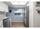 Bright kitchen features stainless steel appliances, light countertops and a window over-looking the back yard at 5 Greenfern Cir, Ormond Beach, FL 32174