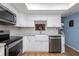 Updated kitchen with white cabinets, stainless steel appliances, a farmhouse sink, and granite countertops at 5 Greenfern Cir, Ormond Beach, FL 32174