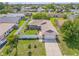 Exterior showcasing well-maintained landscaping, white fence, an attached two car garage and a tidy yard at 5478 Landis Ave, Port Orange, FL 32127