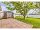 Well-maintained backyard with a large shed, a relaxing swing, and a paved patio area at 5478 Landis Ave, Port Orange, FL 32127