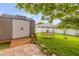Charming backyard with a storage shed, swing, and lush greenery, creating a serene outdoor space at 5478 Landis Ave, Port Orange, FL 32127