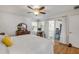 Sunlit bedroom with wood floors, ceiling fan, and access to an outdoor patio at 5478 Landis Ave, Port Orange, FL 32127