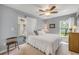 Cozy bedroom with neutral walls, carpet flooring, and a view to an enclosed porch with a swing at 5478 Landis Ave, Port Orange, FL 32127