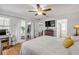 Bedroom featuring wood floors, ceiling fan, and a view to outdoor patio at 5478 Landis Ave, Port Orange, FL 32127